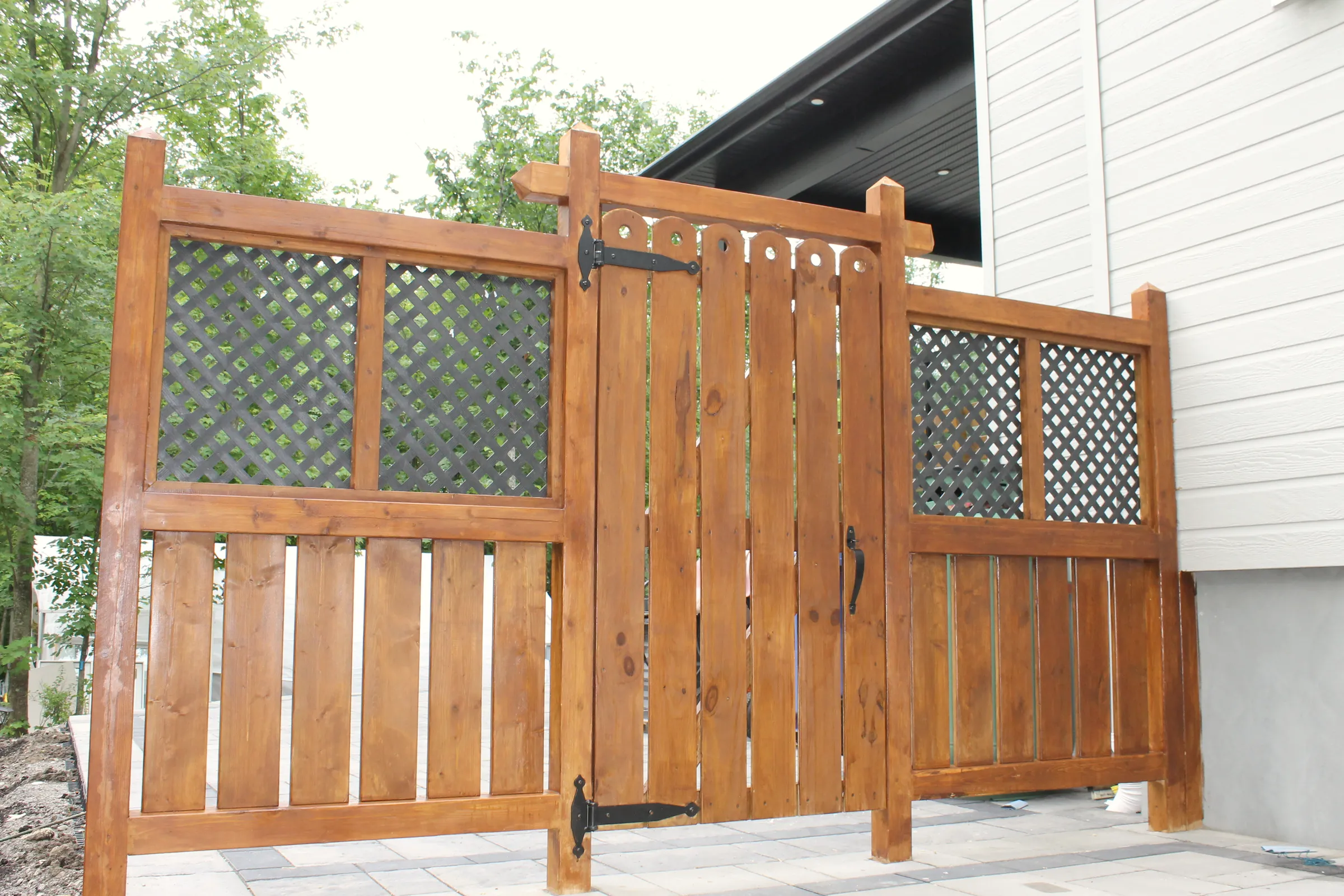 Finished custom wood gate on paver patio by ToughJobs